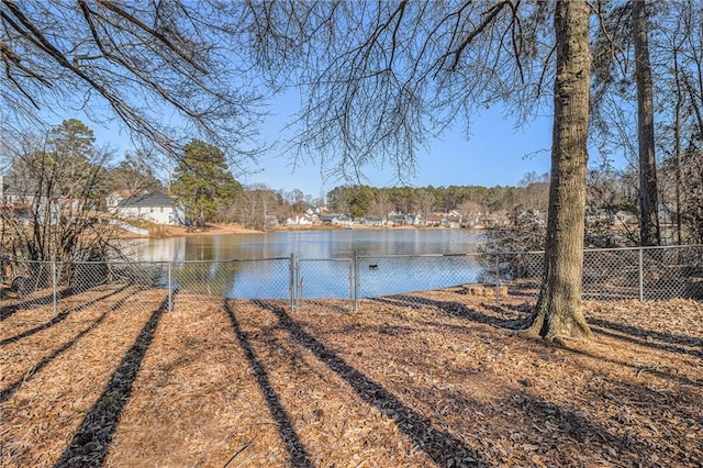 view of yard with a water view and fence