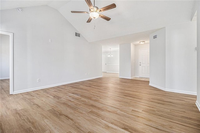 spare room with visible vents, light wood-style flooring, baseboards, and ceiling fan with notable chandelier