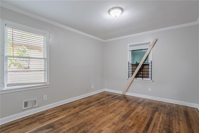 941 Reed Ave, Atlanta, GA 30344 - unfurnished room featuring crown molding, baseboards, dark wood-type flooring, and stairs