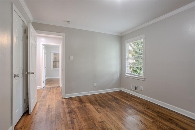941 Reed Ave, Atlanta, GA 30344 - empty room featuring dark wood-style flooring, baseboards, ornamental molding, and a smoke detector