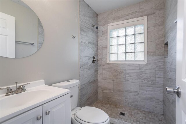 941 Reed Ave, Atlanta, GA 30344 - full bathroom with a tile shower, toilet, and vanity