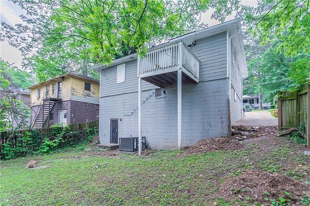 941 Reed Ave, Atlanta, GA 30344 - back of property with a balcony, fence, concrete block siding, and central air condition unit