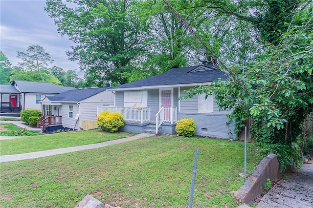 941 Reed Ave, Atlanta, GA 30344 - view of front of home with a front yard, brick siding, crawl space, and a porch