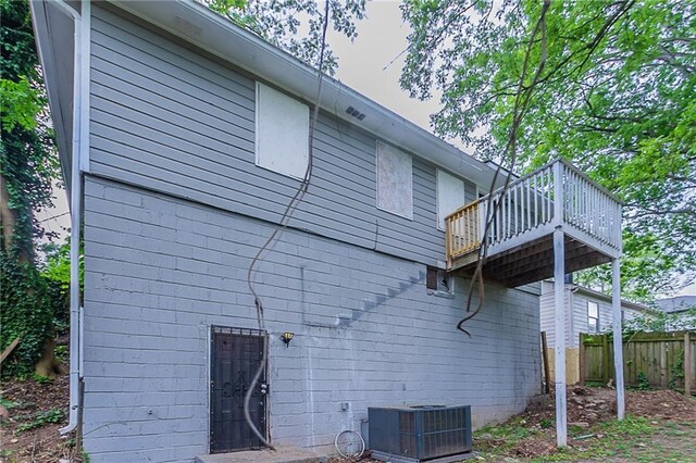 941 Reed Ave, Atlanta, GA 30344 - rear view of property with central AC, a deck, and fence