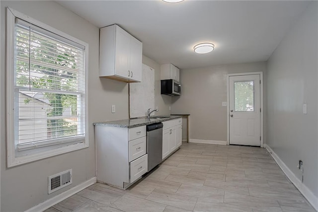 941 Reed Ave, Atlanta, GA 30344 - kitchen with appliances with stainless steel finishes, white cabinets, baseboards, and a sink