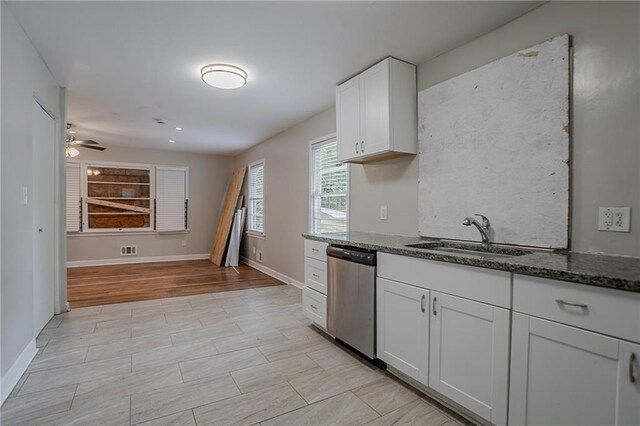 941 Reed Ave, Atlanta, GA 30344 - kitchen featuring dishwasher, a sink, dark stone countertops, white cabinetry, and a ceiling fan