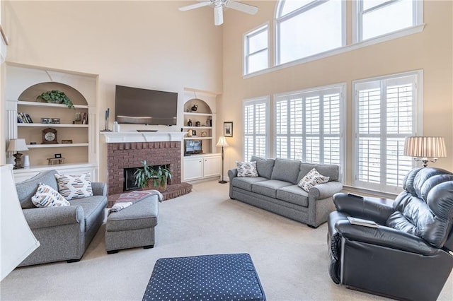 living area with built in features, a brick fireplace, plenty of natural light, and carpet floors