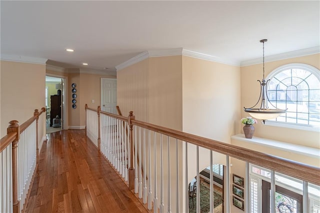 hallway featuring recessed lighting, an upstairs landing, ornamental molding, and hardwood / wood-style flooring