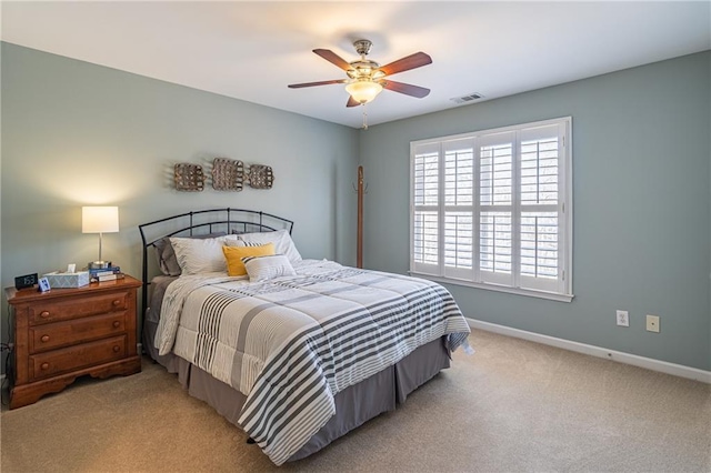 carpeted bedroom featuring visible vents, baseboards, and ceiling fan