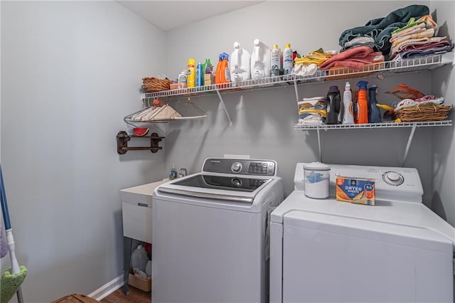 clothes washing area featuring washer and clothes dryer and laundry area