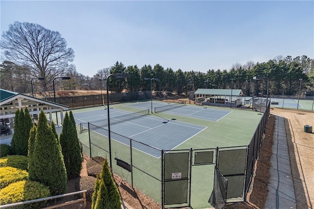 view of sport court featuring a gate and fence