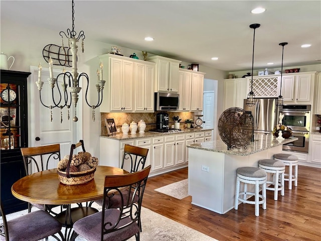4745 Belcrest Way, Cumming, GA 30040 - kitchen with stainless steel appliances, white cabinets, dark wood-style flooring, tasteful backsplash, and a center island