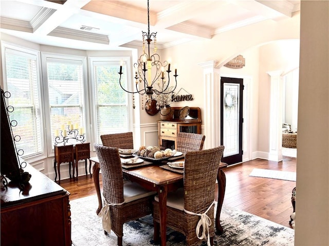 4745 Belcrest Way, Cumming, GA 30040 - dining area featuring a chandelier, plenty of natural light, dark wood-style flooring, beam ceiling, and crown molding