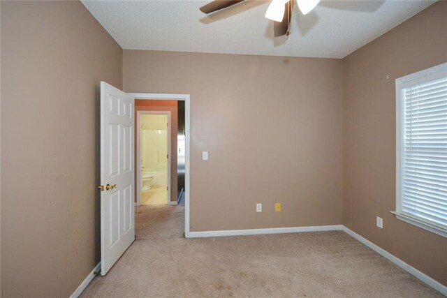 carpeted empty room featuring ceiling fan