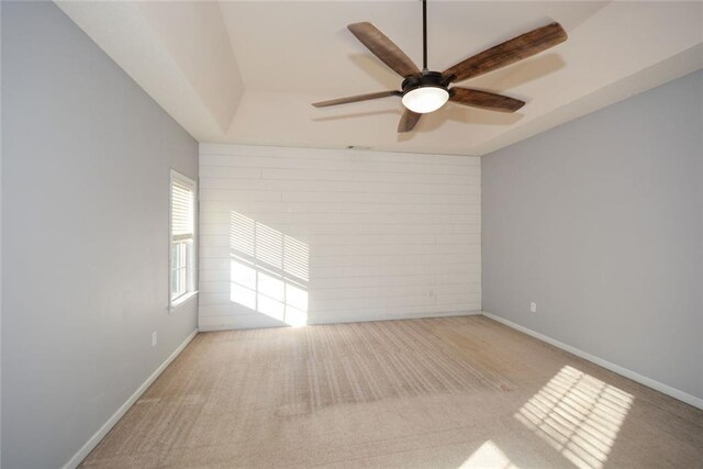 empty room with ceiling fan and light carpet