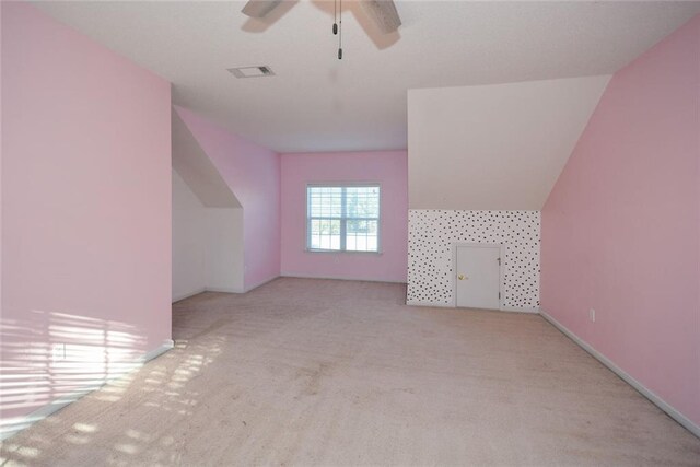 bonus room featuring ceiling fan, light carpet, and vaulted ceiling