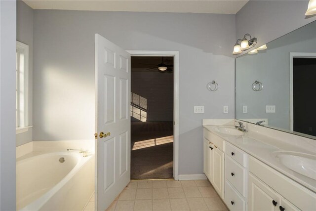 bathroom featuring a tub to relax in, tile patterned flooring, and vanity