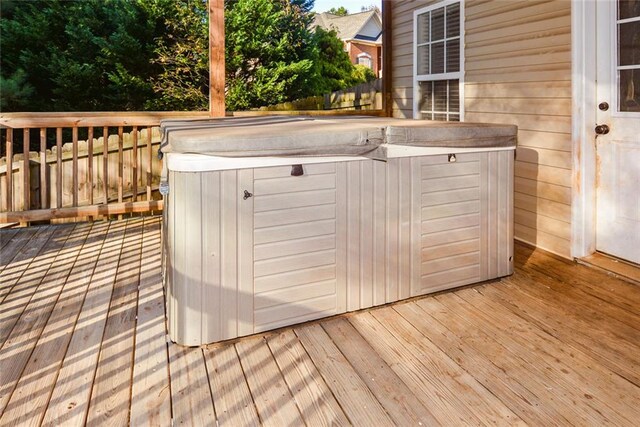 wooden deck featuring a hot tub