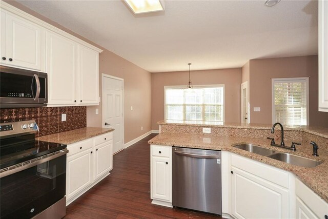 kitchen with white cabinets, dark hardwood / wood-style floors, sink, and appliances with stainless steel finishes