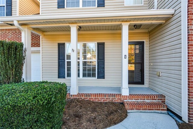 doorway to property with covered porch