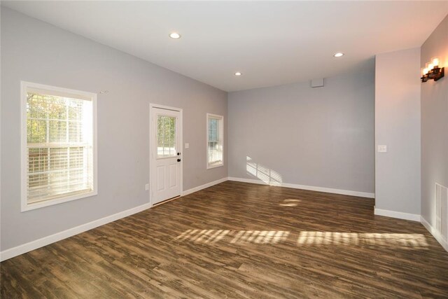 entrance foyer featuring dark hardwood / wood-style flooring and a healthy amount of sunlight