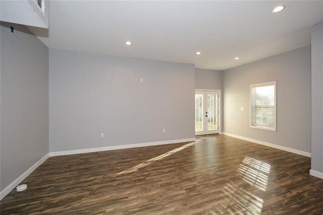 empty room featuring dark wood-type flooring and french doors