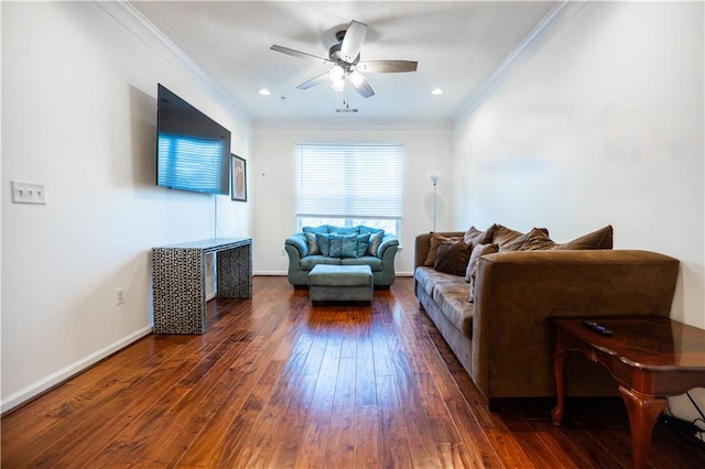 living area featuring baseboards, a ceiling fan, ornamental molding, dark wood-type flooring, and recessed lighting