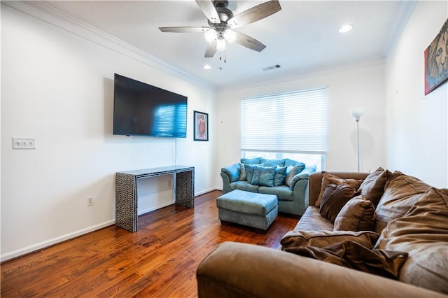 living area featuring ceiling fan, ornamental molding, dark wood-style flooring, and baseboards