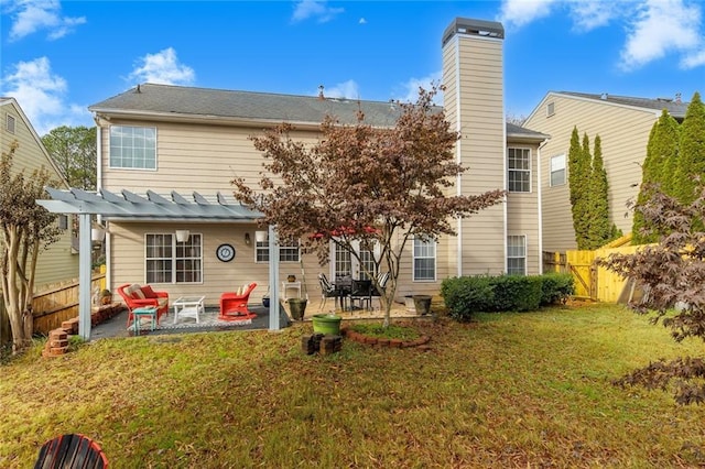 back of house featuring a lawn and a patio