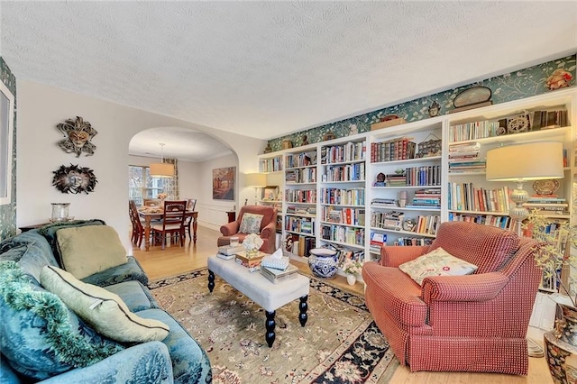 living area with wood-type flooring and a textured ceiling