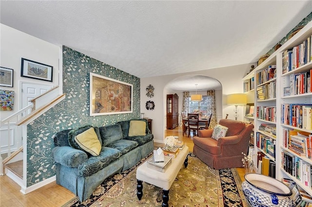 living room with a textured ceiling and hardwood / wood-style flooring