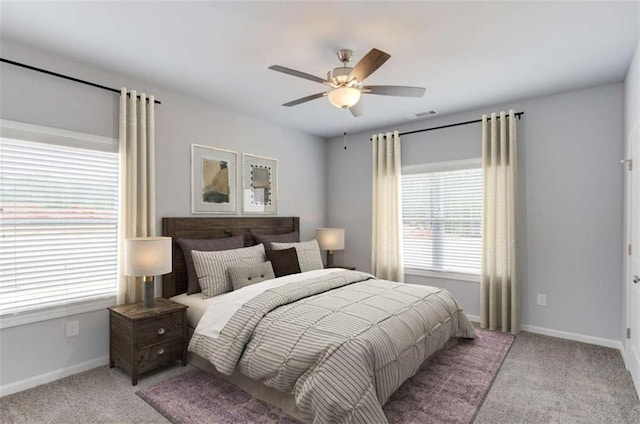 bedroom with light colored carpet, baseboards, ceiling fan, and visible vents