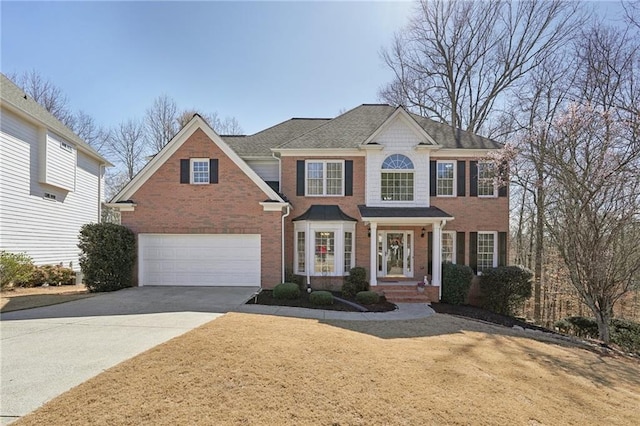 view of front of home with a garage, concrete driveway, and brick siding