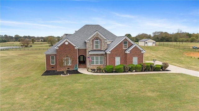 traditional-style home featuring brick siding, a front yard, and fence