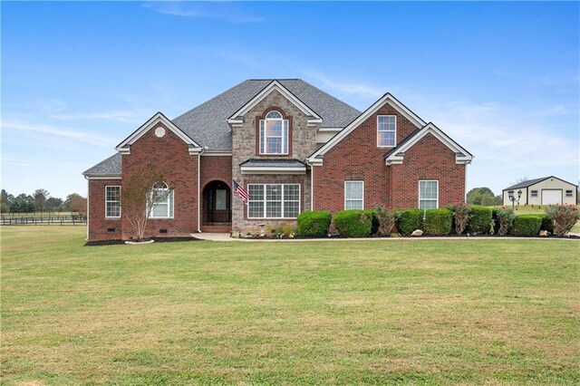 rear view of property with a lawn, ceiling fan, and a porch