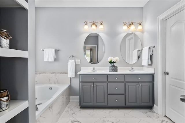 full bath featuring a sink, a garden tub, marble finish floor, and double vanity