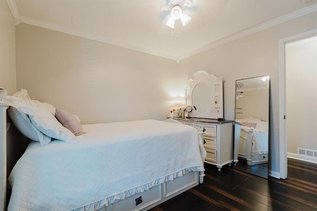 bedroom featuring dark wood-style floors, visible vents, ornamental molding, and baseboards