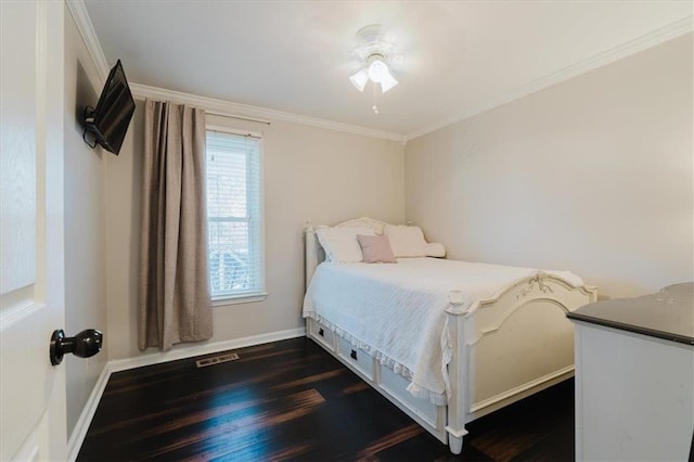 bedroom featuring crown molding, visible vents, dark wood finished floors, and baseboards