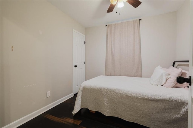 bedroom with a ceiling fan, baseboards, and dark wood-style flooring