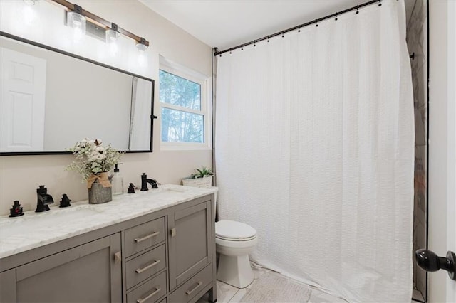 bathroom with double vanity, a shower with shower curtain, a sink, and toilet