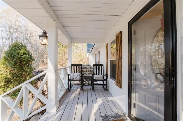 wooden terrace with a porch