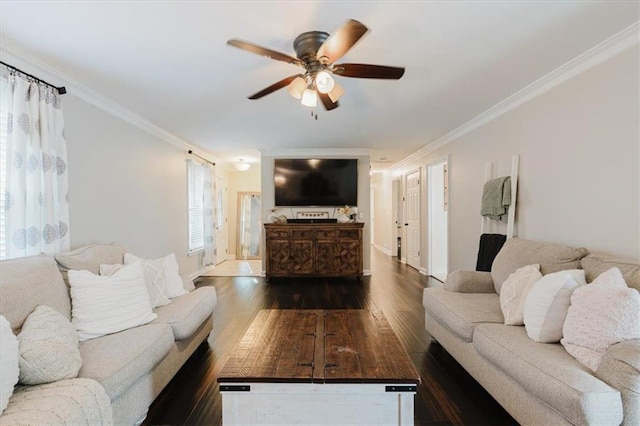 living area featuring dark wood-type flooring, ornamental molding, baseboards, and ceiling fan