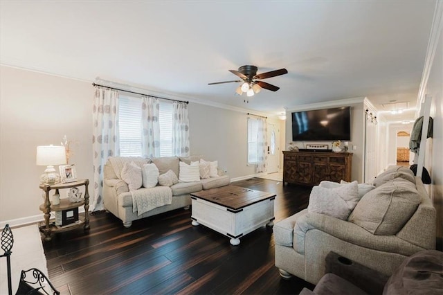 living room featuring dark wood-type flooring, ornamental molding, baseboards, and a ceiling fan