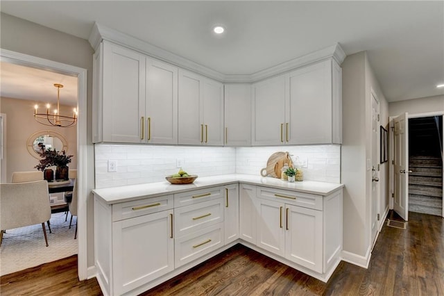 kitchen featuring tasteful backsplash, white cabinetry, and dark hardwood / wood-style flooring