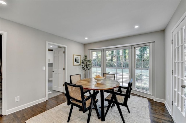 dining area with dark hardwood / wood-style floors