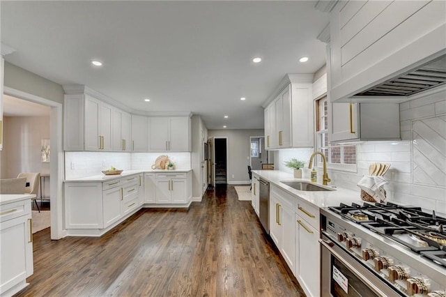 kitchen with appliances with stainless steel finishes, dark hardwood / wood-style floors, white cabinetry, and tasteful backsplash