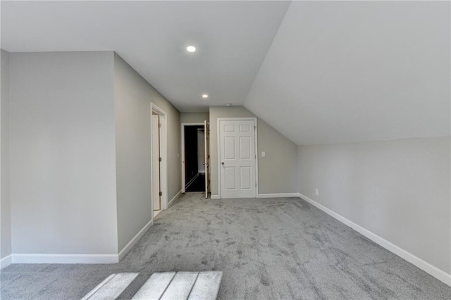 additional living space with light colored carpet and lofted ceiling