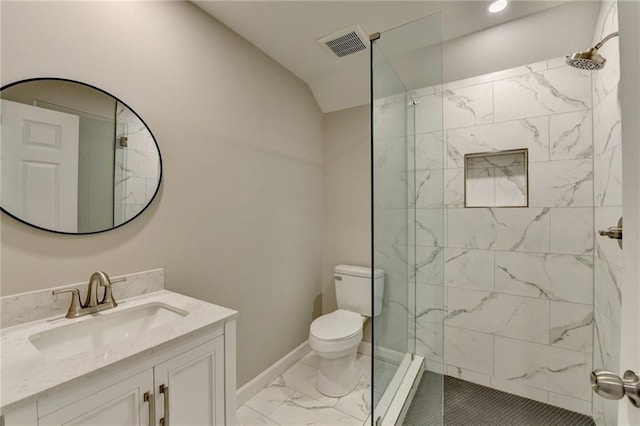 bathroom featuring a tile shower, vanity, lofted ceiling, and toilet