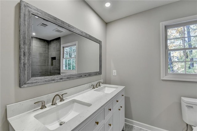 bathroom with tile patterned flooring, vanity, and toilet