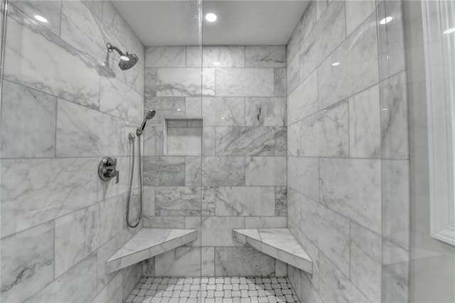 bathroom with a tile shower